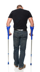 Caucasian man with crutches back view isolated white background