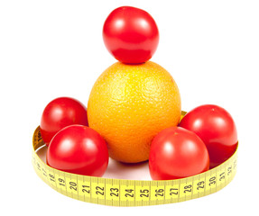 Tomatoes and orange with measuring band