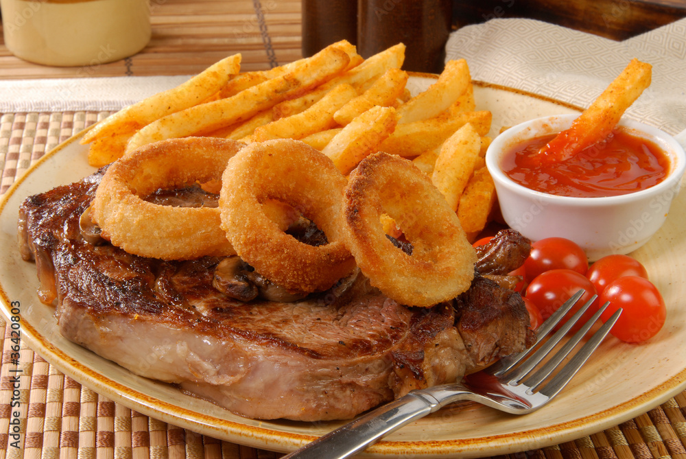 Sticker steak with fries and onion rings