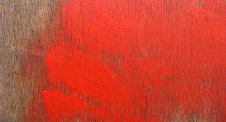 bright red paint stroke on timber wood panel