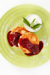 Cheese pancakes with sour cream and jam