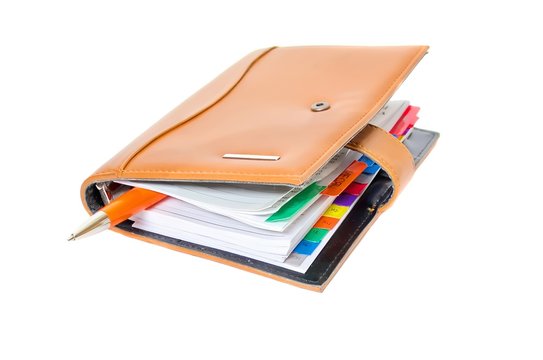 Daily planner with pen on a white background