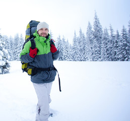 Hiker walks in snow forest