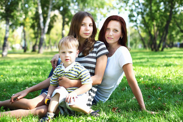 Fototapeta premium Young mother with her son in summer park
