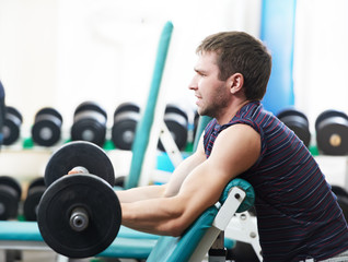 Fototapeta na wymiar bodybuilder lifting weight at sport gym