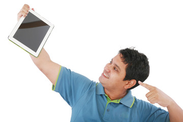 Laughing casual young man holding a touch pad tablet pc on isola