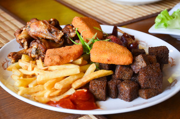 Plate with assorted pub snack on the table