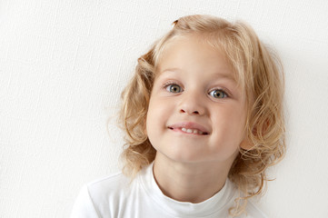 Blonde little girl  dressed in white