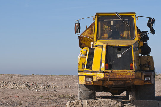 Front view of a yellow Dump truck