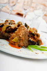 Meat under tasty sauce in plate