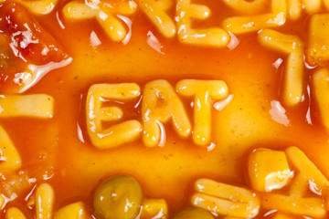 Pasta forming the word EAT in tomato sauce