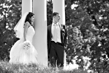 Bride and groom at wedding walk around column