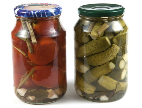 Preserved tomatoes and cucumbers in jars