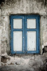 Blue window on grunge wall