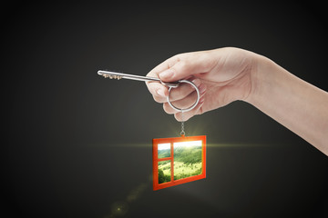 Hand holding key with a keychain