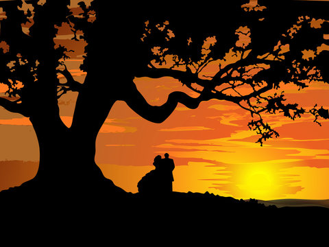 Silhouette of couple in love to tree at sunset