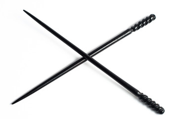 Two Black chopsticks isolated on white ornate decorations
