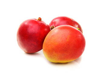 Ripe mangos on a white background.