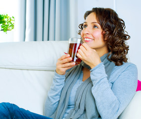 Beautiful Young Woman drinking hot tea