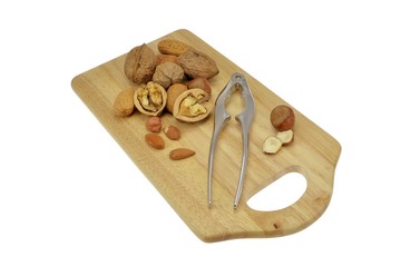 Selection of nuts on an isolated wooden board