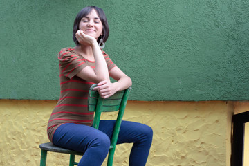 young woman posing on a chair