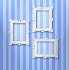 Set of white ornamental frames on a stripy wallpaper