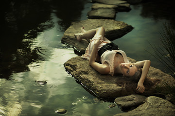 Beautiful lady lying on rocks