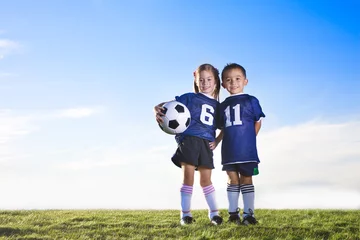 Foto op Plexiglas Cute youth soccer players wearing their team uniforms © Brocreative