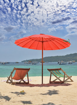 Red Beach Umbrella And Deck Chairs