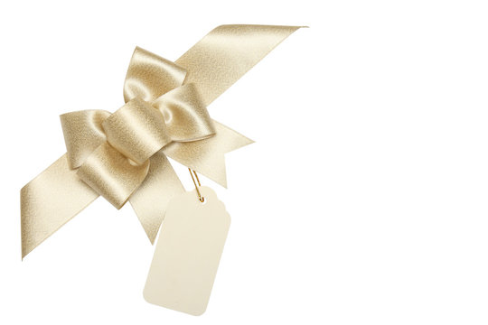 Golden ribbon bow with blank gift tag