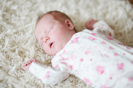 Adorable sleeping newborn baby girl portrait