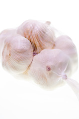 Bulbs of garlic in a bag close up