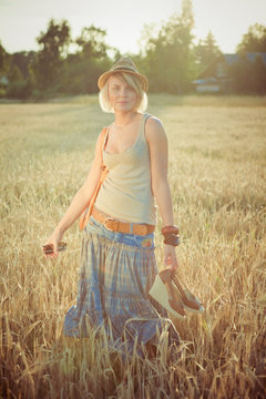 Image of young fashion woman on wheat field