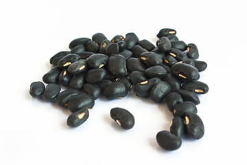 A small handful of black beans - preto. Beans isolated on a whit