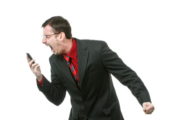 Young angry businessman screaming on cell phone