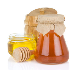 glass jar full of honey and stick