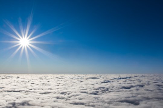 sparkle sun above dense clouds