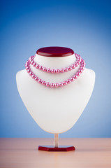Pearl necklace against gradient background