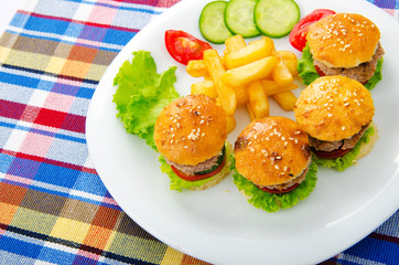 Plate with tasty mini burgers