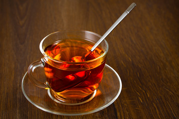Cup of fragrant tea with fresh leaves of green tea
