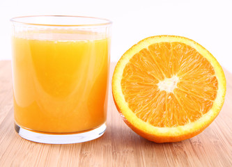 Glass of Orange juice and a half of an orange