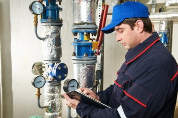 heating engineer repairman in boiler room