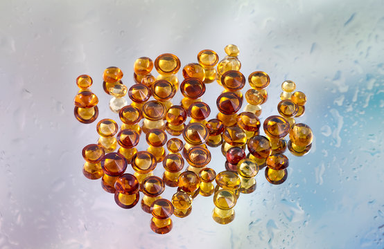 Group of citrine gemstones on wet mirror.