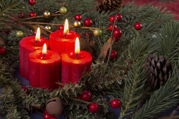 red advent candles and berries