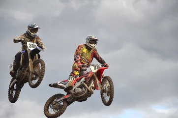 Fotobehang Flying high two motocross racing against © VVKSAM