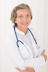 Senior doctor female with stethoscope smiling