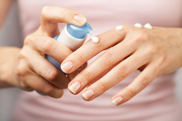 woman applying cream on hands