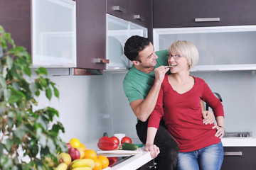 young couple have fun in modern kitchen