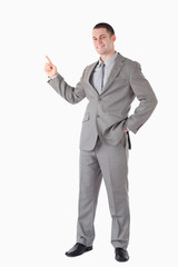 Portrait of a smiling businessman pointing at something