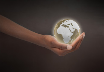 Feminine hand holding a planet globe